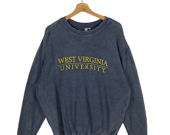 May include: A dark blue sweatshirt with a ribbed texture and the text "West Virginia University" in yellow embroidery.