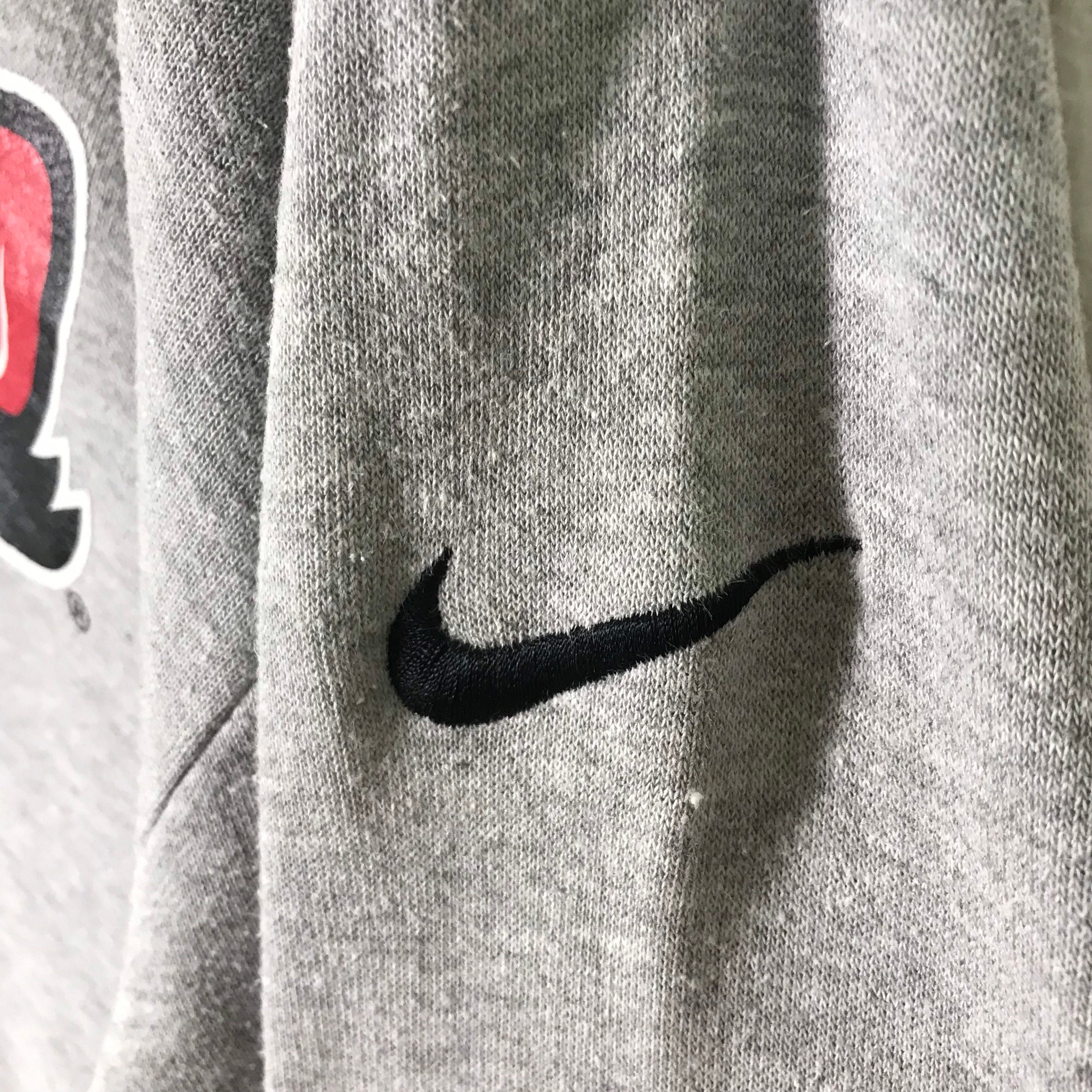 grey nike sweatshirt with red tick