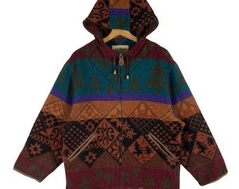 May include: A multi-colored hooded jacket with a zipper closure. The jacket features a geometric pattern in shades of brown, red, blue, green, and purple. The jacket has two pockets on the front.