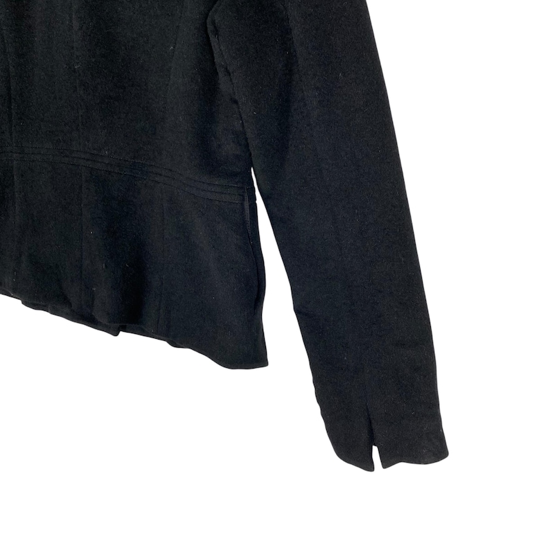 May include: A black blazer with long sleeves and a fitted waist. The blazer has a simple design and is made of a soft, comfortable fabric.
