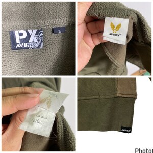 Puede incluir: Chaqueta de forro polar verde oliva con el logo "AVIREX" y una etiqueta de talla "L". La chaqueta tiene una textura suave y un panel marr&oacute;n en contraste en los hombros. La etiqueta "AVIREX" es visible en el cuello y el dobladillo.
