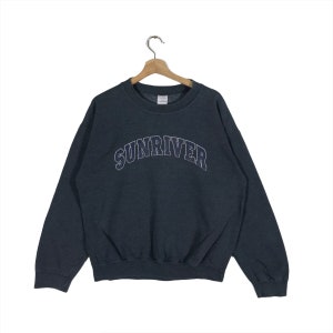 May include: A dark gray sweatshirt with the word "SUNRIVER" embroidered in white on the front.
