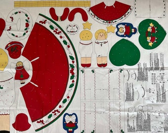 May include: A white fabric with a red and green Christmas tree skirt pattern. The fabric includes patterns for making a Christmas angel doll with a red dress and a white dress. The fabric also includes a heart-shaped pattern with a green background and a star pattern.