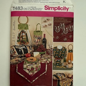May include: Simplicity pattern 1483 OS, featuring various wine-themed sewing projects. Includes patterns for a wine bottle tote, table runner, and kitchen towel. The design showcases grapes, wine bottles, and glasses.
