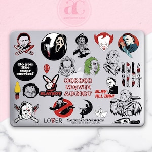 May include: A laptop with a variety of horror movie themed stickers. The stickers feature characters like Jason Voorhees, Freddy Krueger, and Pennywise. The stickers are in black, red, and white.