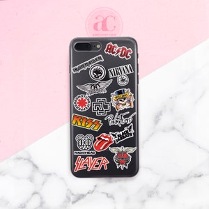 May include: Black phone case with various band logos and names, including Iron Maiden, AC/DC, Nirvana, Red Hot Chili Peppers, Kiss, Pink Floyd, Black Sabbath, Radiohead, Slayer, and Bon Jovi.