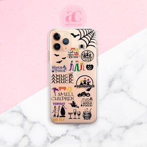 May include: A clear phone case with a black and white design featuring the Sanderson sisters from the movie Hocus Pocus. The case has various quotes from the movie, including "I put a spell on you", "Hocus Pocus", "Amuck Amuck Amuck", "I smell children", "It's just a bunch of Hocus Pocus", and "We Fly".
