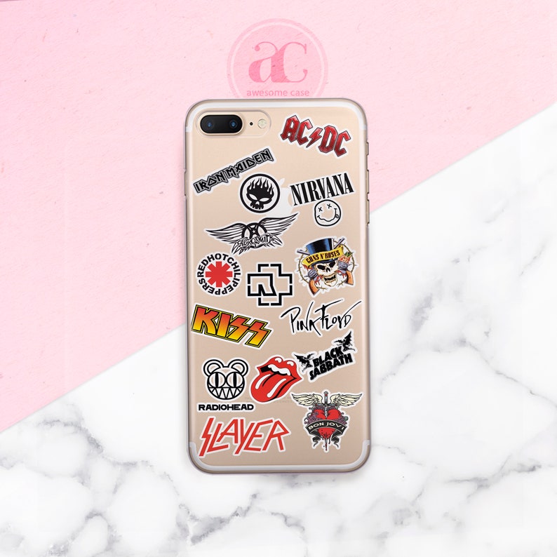 May include: A gold iPhone case with various band logos and stickers, including AC/DC, Iron Maiden, Nirvana, Red Hot Chili Peppers, KISS, Pink Floyd, Black Sabbath, Radiohead, Slayer, and Bon Jovi.