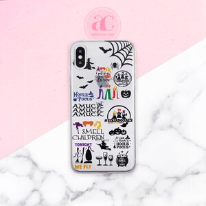 May include: A clear phone case with a variety of Hocus Pocus themed stickers. The stickers feature the Sanderson sisters, pumpkins, bats, and quotes from the movie. The case is designed for an iPhone.