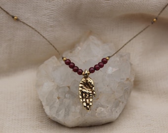Small hand pendant red garnet pure golden brass healing stone somatic jewelry for body workers and artists