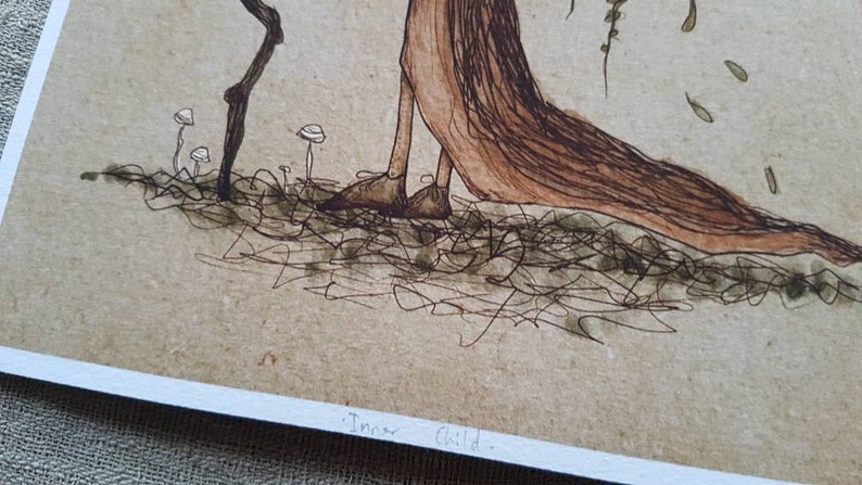 May include: A black and white ink drawing of a tree-like figure with a long flowing skirt. The figure is standing on a bed of leaves and mushrooms. The text "Inner Child" is written at the bottom of the image.