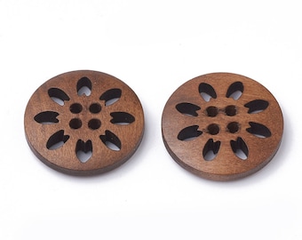 May include: Two brown wooden buttons with a carved flower design. The buttons have a circular shape and a hole in the center.