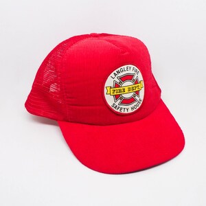 May include: Red mesh trucker hat with a yellow and red patch that says "Langley Fire Safety House Fire Dept."