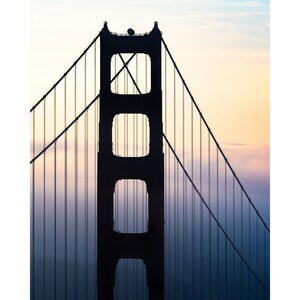 May include: A silhouette of the Golden Gate Bridge in San Francisco, California. The bridge is a suspension bridge with two towers and a roadway that connects the city to Marin County. The bridge is a popular tourist destination and a symbol of the city.