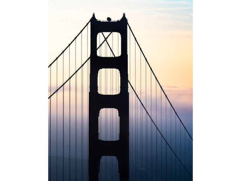 May include: A silhouette of the Golden Gate Bridge in San Francisco, California. The bridge is a suspension bridge with two towers and a roadway that connects the city to Marin County. The bridge is a popular tourist destination and a symbol of the city.