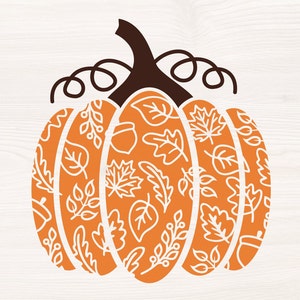 May include: Orange pumpkin with a white outline of leaves and acorns. The pumpkin has a brown stem with a curly vine.