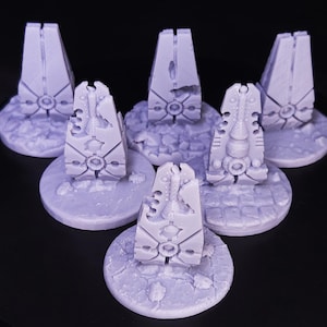 May include: Six light purple miniature obelisks with intricate designs, each mounted on a circular base. The obelisks have a detailed, futuristic aesthetic, with geometric patterns and a textured surface. The bases have a stone-like appearance.