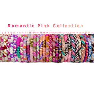 May include: A collection of 33 beaded bracelets in the Romantic Pink Collection. The bracelets feature various patterns and colors, including pink, white, and teal. The text "Romantic Pink Collection" is displayed above the bracelets.