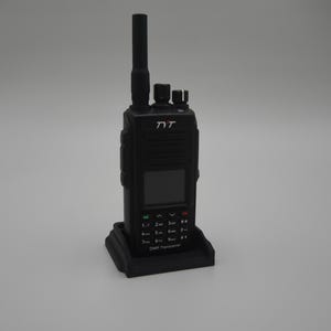 May include: Black two-way radio with an antenna, screen, and keypad, resting on a black base. The radio has the brand name "TYT" printed on the front. The base has a rectangular shape.