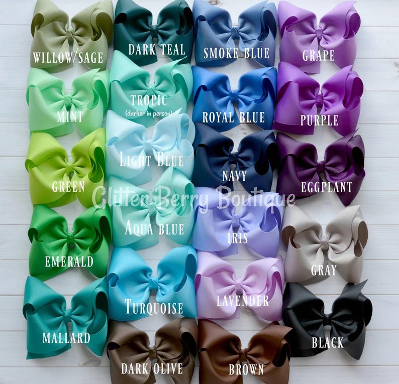 May include: A collection of 20 large, handmade hair bows in various colors, including willow sage, dark teal, smoke blue, grape, mint, tropic, royal blue, purple, green, light blue, navy, eggplant, emerald, aqua blue, iris, gray, turquoise, lavender, mallard, dark olive, brown, and black. The bows are arranged in four rows of five bows each. The text "Glitter Berry Boutique" is visible in the center of the image.