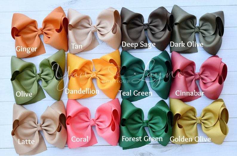 May include: Twelve large hair bows in various colors, including ginger, tan, deep sage, dark olive, olive, dandelion, teal green, cinnabar, latte, coral, forest green, and golden olive.