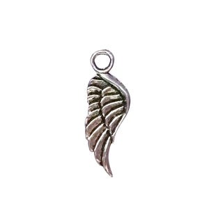 May include: A small, silver-colored wing charm with detailed feather etching. The charm has a loop at the top for attaching to a necklace or bracelet. The wing is slightly curved and has a textured surface.
