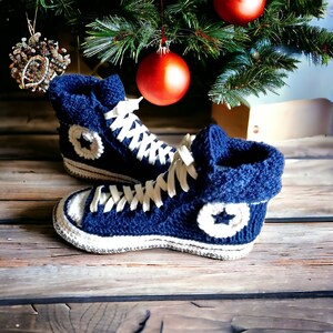 Cozy blue knitted high top sneakers with white laces and white star accents.