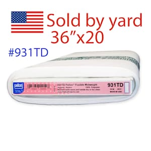 May include: A roll of white Pellon fusible midweight fabric, 36" x 20", with the text "Sold by yard" and the product code #931TD. The label includes washing instructions and the text "MADE IN USA".