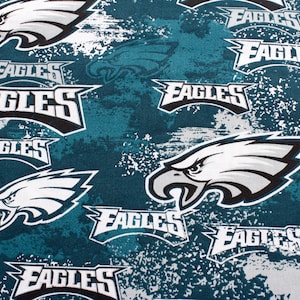 May include: A teal fabric featuring a repeating pattern of the Philadelphia Eagles logo, which consists of a white and black eagle head profile, and the word EAGLES in bold white and black lettering, set against a mottled white and teal background.
