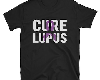 May include: Black t-shirt with the text "CURE LUPUS" in white letters. A purple ribbon is incorporated into the word "CURE".