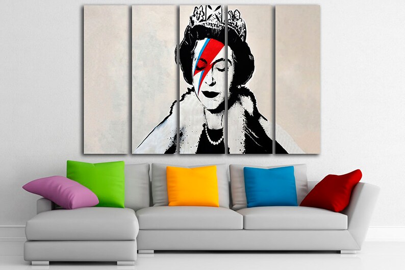 May include: A four-panel canvas print featuring a black and white portrait of Queen Elizabeth II with a red, blue, and white lightning bolt painted over her right eye. The background is a light beige color.