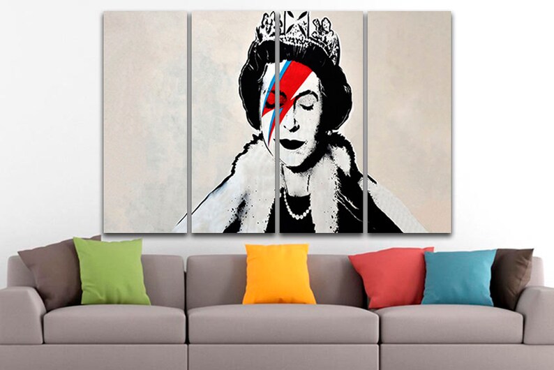 May include: A multi-panel canvas print featuring a black and white portrait of Queen Elizabeth II with a red, blue, and white lightning bolt design over her eye, reminiscent of David Bowie's iconic "Aladdin Sane" album cover.