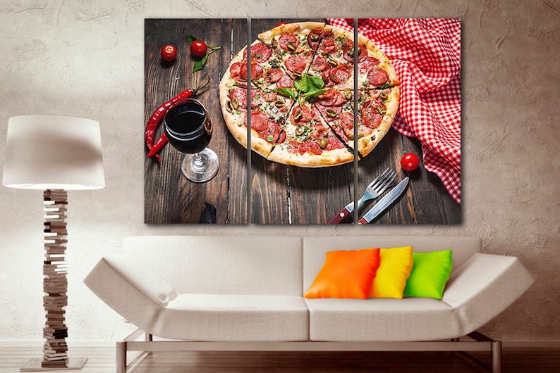 Puede incluir: Una impresi&oacute;n en lienzo de tres paneles que presenta un primer plano de una pizza de pepperoni y aceitunas verdes con una copa de vino tinto y pimientos rojos sobre una mesa de madera. La pizza est&aacute; cortada en rodajas y adornada con albahaca fresca.
