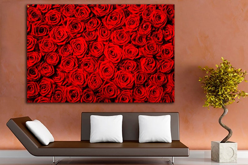 May include: A close-up image of a wall of red roses. The roses are tightly packed together, creating a beautiful and romantic backdrop.