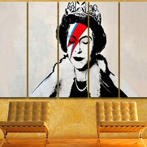 May include: A multi-panel canvas print featuring a black and white portrait of Queen Elizabeth II with a red, blue, and white lightning bolt painted over her right eye. The queen is wearing a crown and a fur collar.