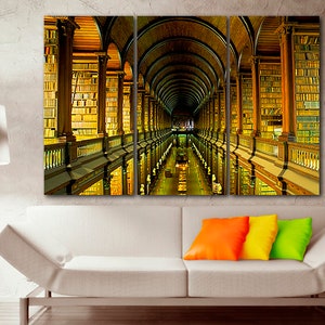 May include: A three-panel canvas print of a long, arched hallway lined with bookshelves. The shelves are filled with books, and the hallway is lit by natural light. The print is a great way to add a touch of sophistication to any room.