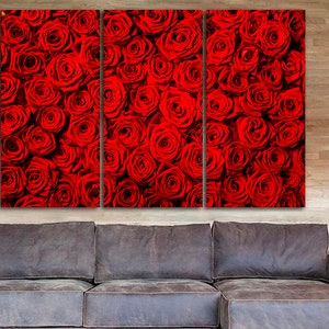 May include: A close-up of a wall art print featuring a red rose pattern. The print is divided into three panels, each showing a different section of the rose pattern.