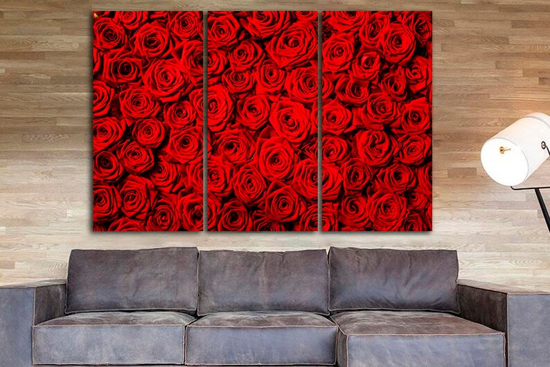May include: A close-up of a wall art print featuring a red rose pattern. The print is divided into three panels, each showing a different section of the rose pattern.