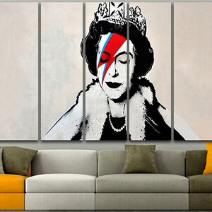 May include: A multi-panel canvas print featuring a black and white portrait of Queen Elizabeth II with a red, blue, and white lightning bolt painted across her face, reminiscent of David Bowie's iconic makeup.