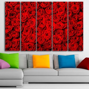 May include: A multi-panel canvas print featuring a close-up of a wall of red roses. The print is displayed on a white wall above a gray couch with colorful throw pillows.