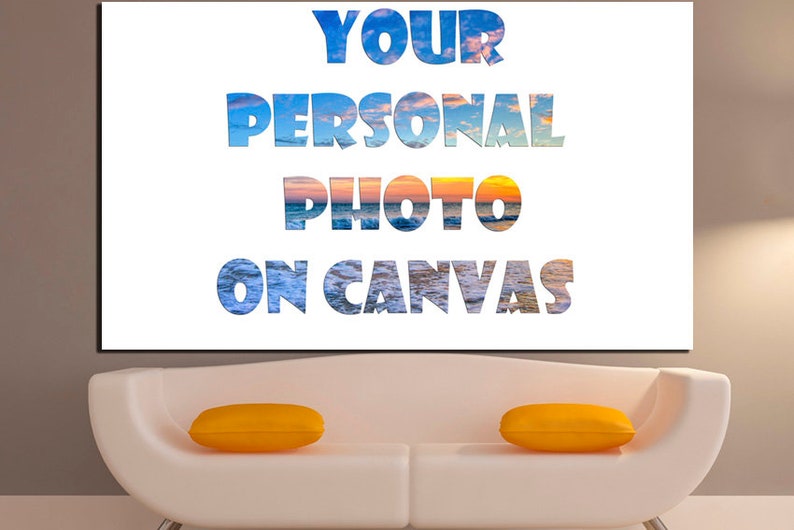 May include: A white canvas with the text "YOUR PERSONAL PHOTO ON CANVAS" in blue and white letters. The letters are filled with a sunset and ocean scene.