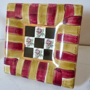 Peut inclure: Une tasse en c&eacute;ramique blanche avec une anse noire et le texte "But First, Coffee" en gras noir. La tasse est pos&eacute;e sur un fond flou, soulignant son design &eacute;pur&eacute;.