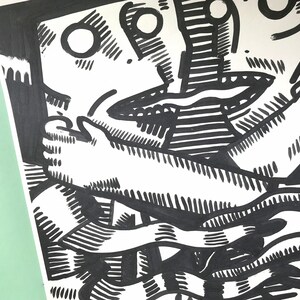 May include: Black and white ink drawing of two figures intertwined. The figures are drawn in a stylized, abstract style with exaggerated features. The drawing is done on a white background.