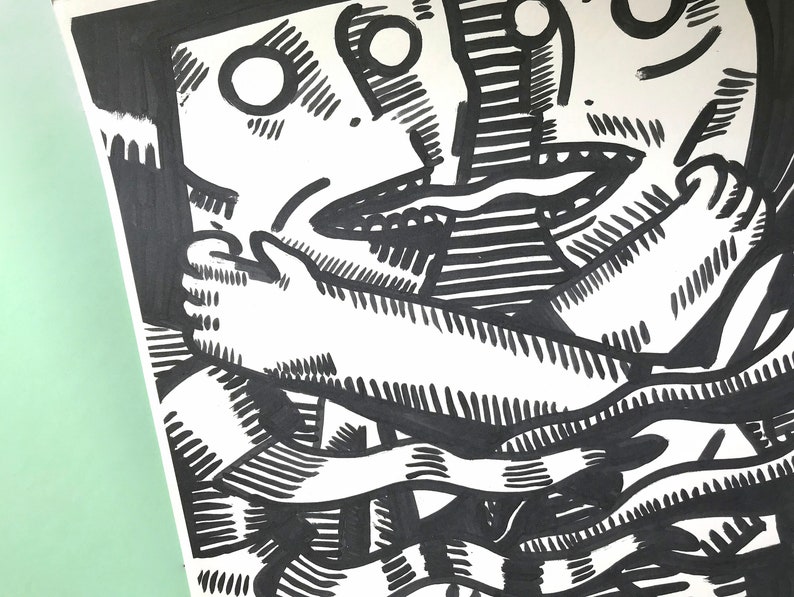 May include: Black and white ink drawing of two figures intertwined. The figures are drawn in a stylized, abstract style with exaggerated features. The drawing is done on a white background.
