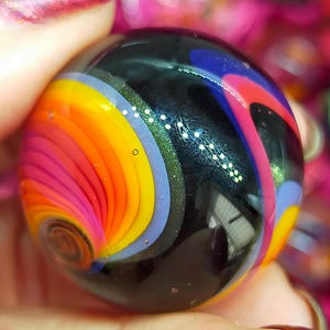 Borosilicate glass marble with beautiful intense colors and sparkles!