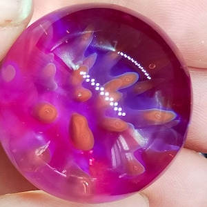 Anenome marble, handmade from Borosilicate Glass. Has lovely translucent pinks, purples and blues.