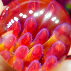 Anenome marble, handmade from Borosilicate Glass. Has lovely translucent pinks, salmon pink, purples and blues.