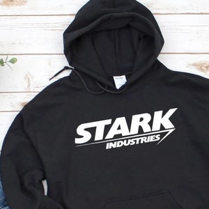 May include: Black hooded sweatshirt with a white graphic print of "STARK INDUSTRIES" on the front.