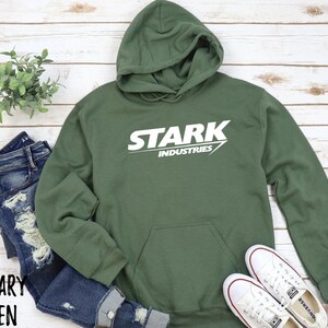 May include: A green hooded sweatshirt with the words "Stark Industries" printed in white on the front.