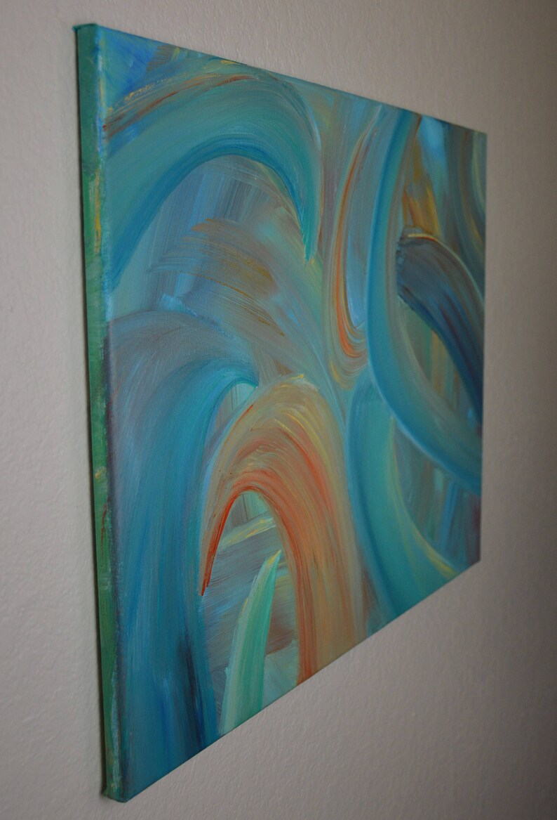 May include: Abstract painting on canvas with swirling blue, green, and orange hues. The painting has a textured surface and is framed with a green border.